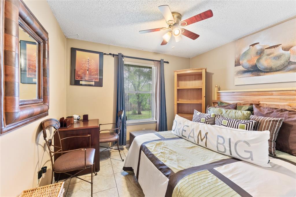 9083 Sable Ridge Court Jacksonville, FL 32244 - Photo 20 of 38 a bedroom with a bed and wooden floor