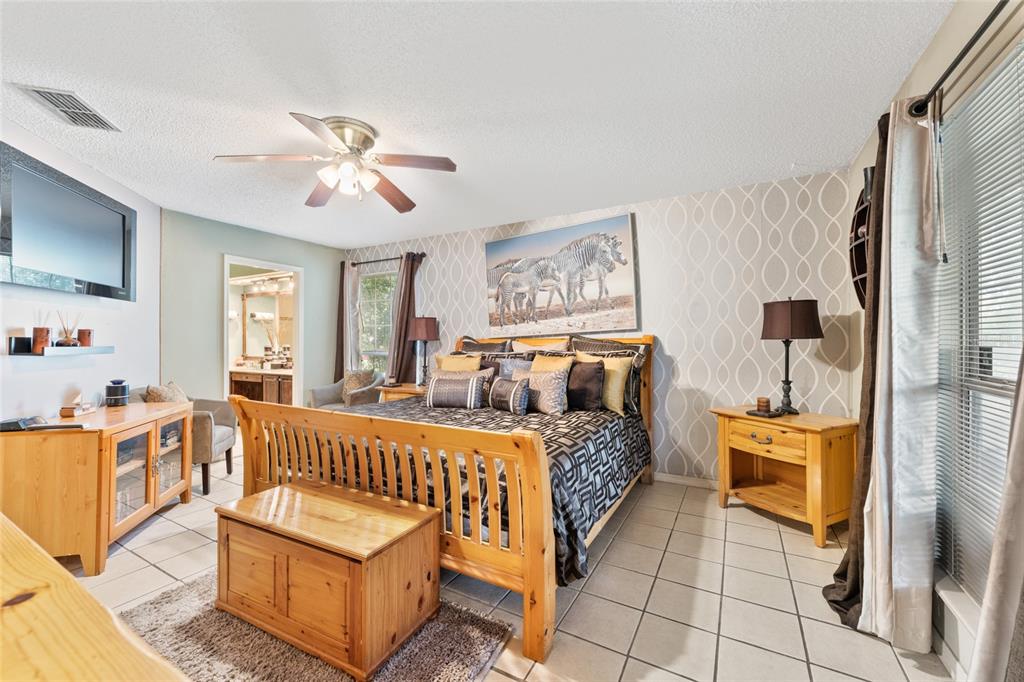 9083 Sable Ridge Court Jacksonville, FL 32244 - Photo 22 of 38 a bedroom with furniture and wooden floor