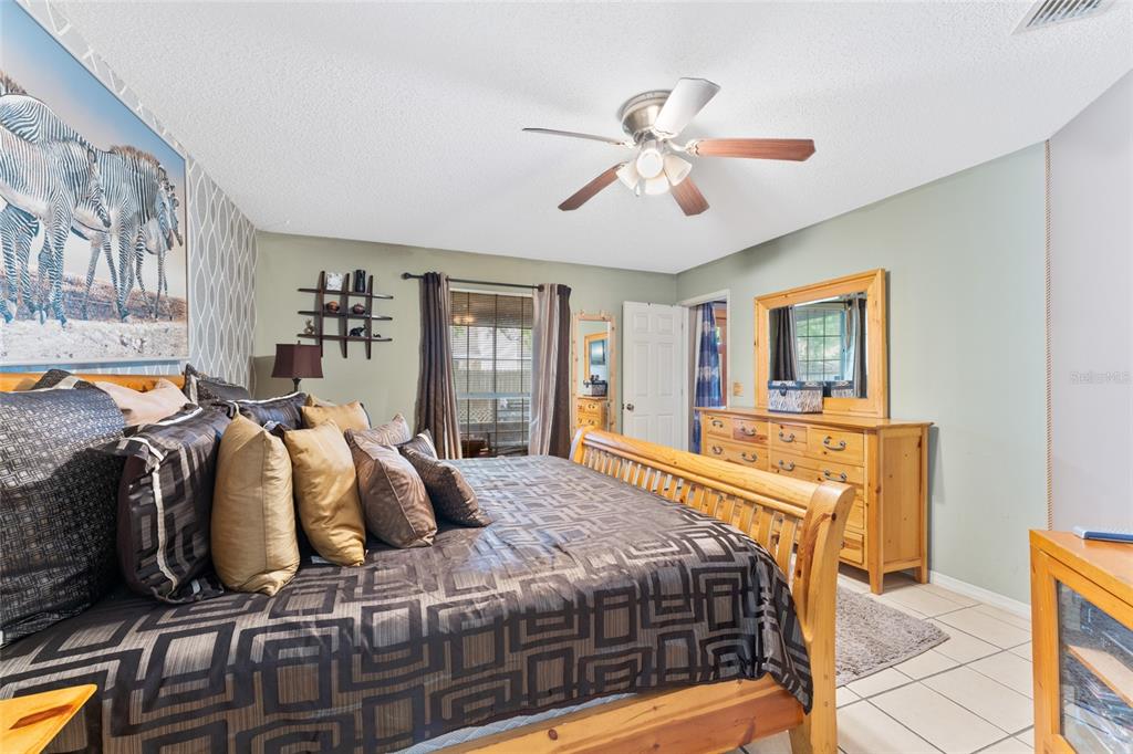 9083 Sable Ridge Court Jacksonville, FL 32244 - Photo 23 of 38 a bedroom with a bed and wooden floor