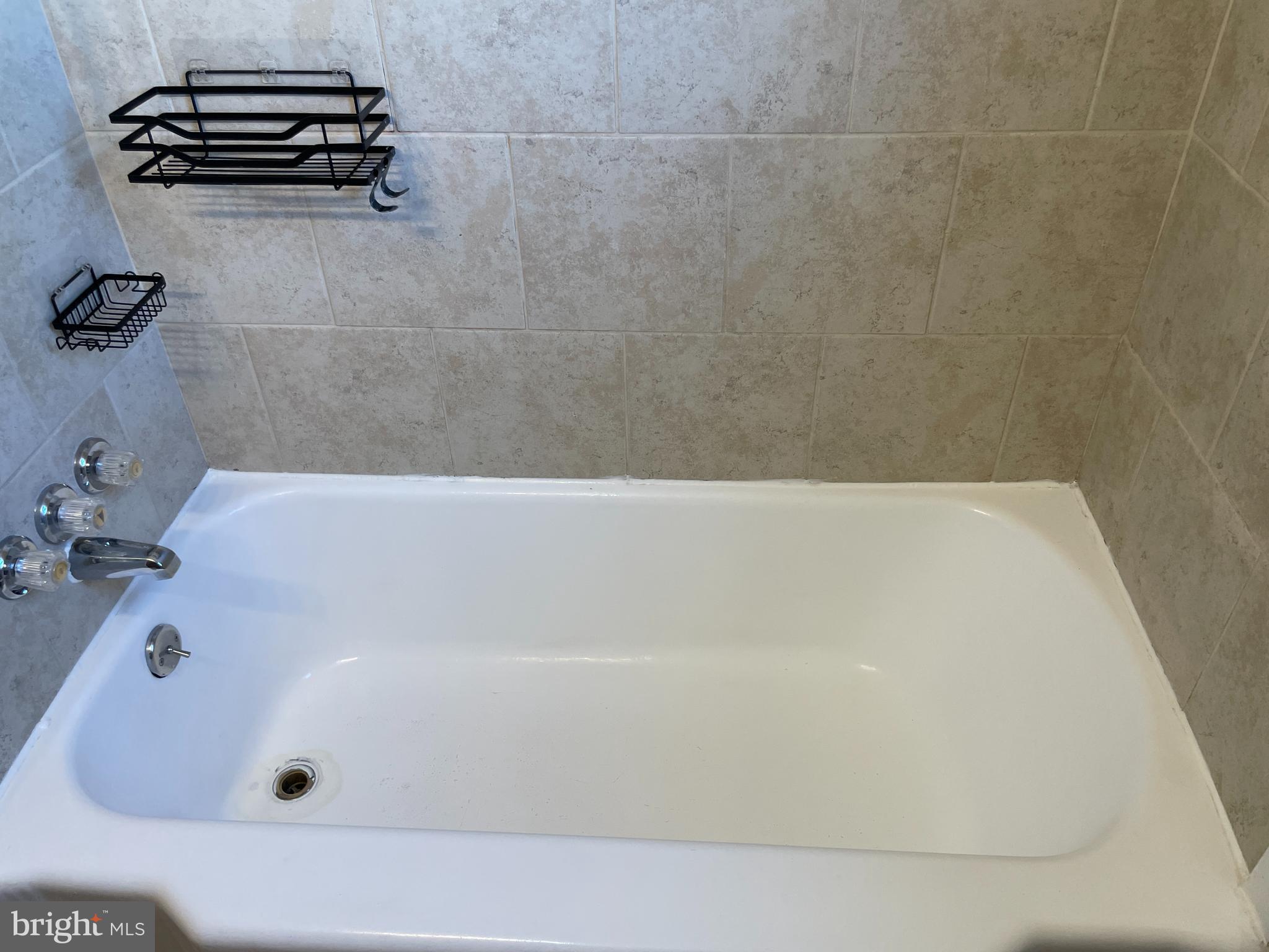 1067 North Mildred Street Ranson, WV 25438 - Photo 20 of 38 a bathroom with a bath tub