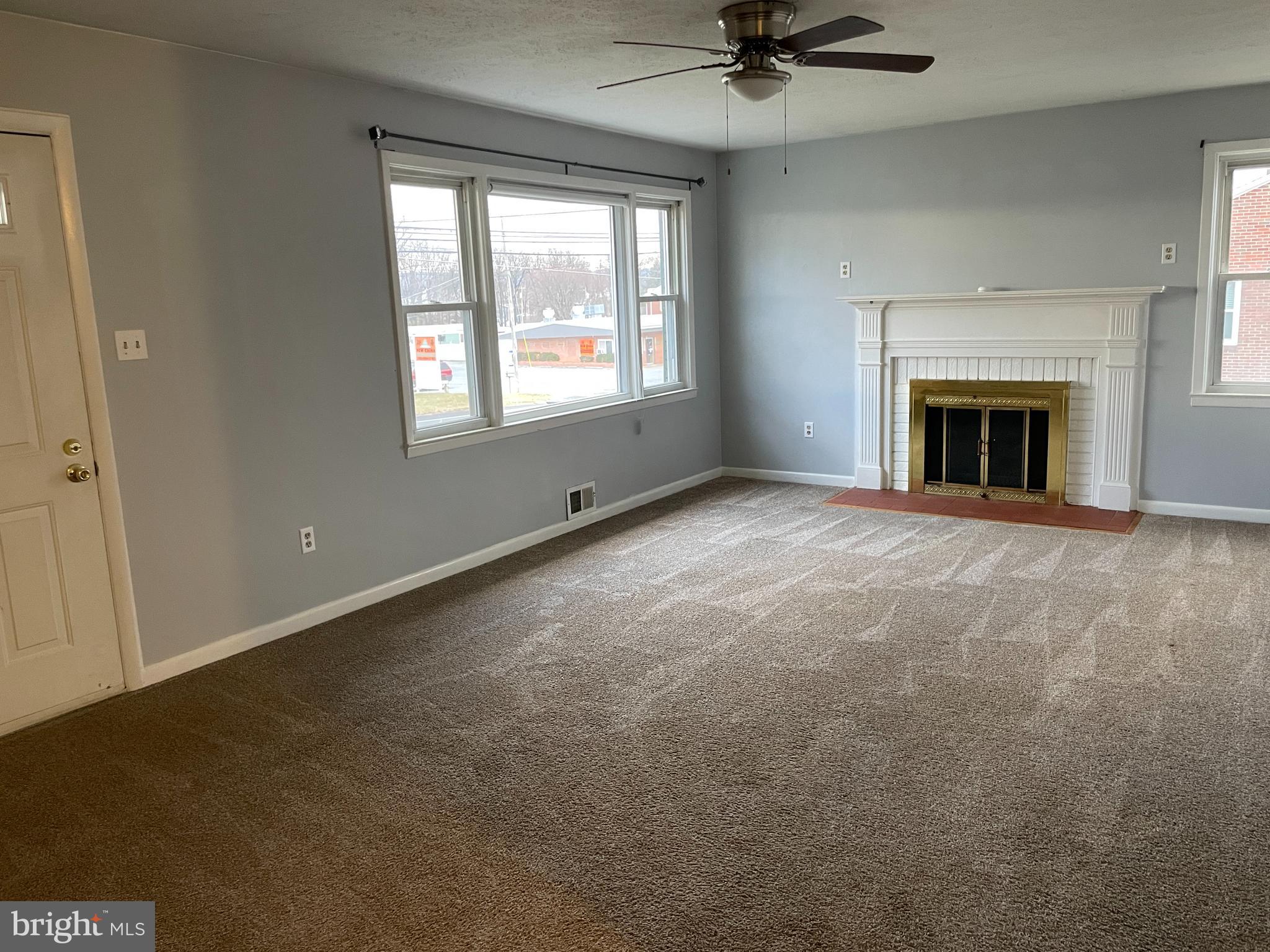 1067 North Mildred Street Ranson, WV 25438 - Photo 9 of 38 a view of an empty room with a fireplace and a window