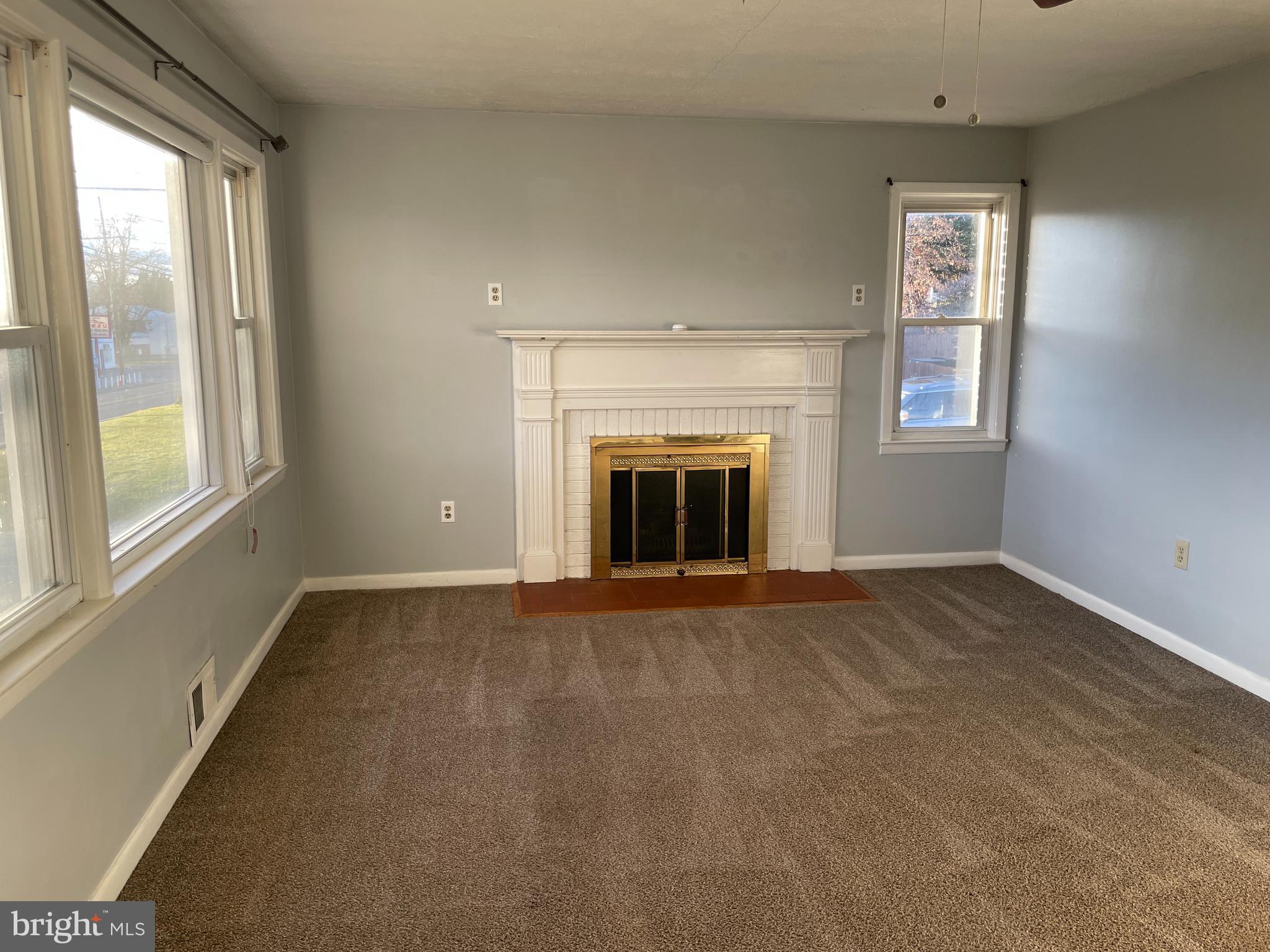 1067 North Mildred Street Ranson, WV 25438 - Photo 10 of 38 an empty room with windows and fireplace