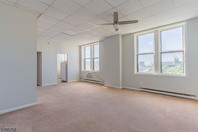 110 Cornelia Street, Unit 3 Boonton, NJ 07005 - Photo 3 of 14 an empty room with windows