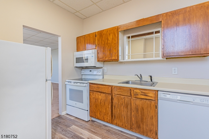 110 Cornelia Street, Unit 3 Boonton, NJ 07005 - Photo 6 of 14 a kitchen with stainless steel appliances granite countertop a sink stove and refrigerator