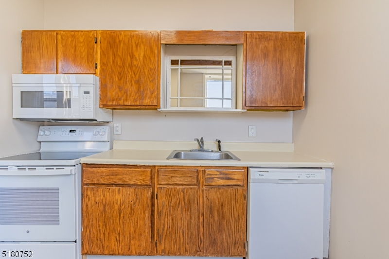 110 Cornelia Street, Unit 3 Boonton, NJ 07005 - Photo 7 of 14 a kitchen with stainless steel appliances granite countertop a sink and cabinets