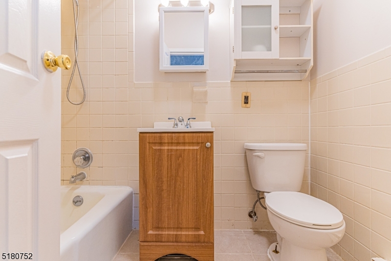 110 Cornelia Street, Unit 3 Boonton, NJ 07005 - Photo 8 of 14 a bath room with a toilet and a bath tub