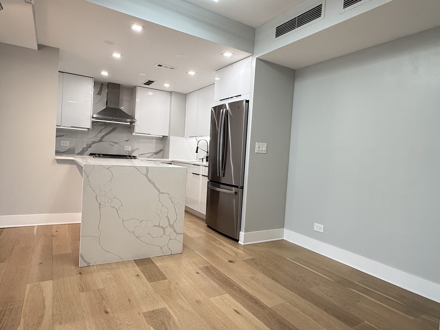 Undisclosed Address Chicago, IL 60657 - Photo 3 of 15 a kitchen with stainless steel appliances granite countertop a refrigerator a stove a sink and a microwave