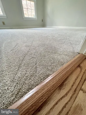 a view of wooden floor with windows