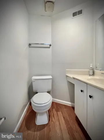 a bathroom with a toilet sink and a mirror