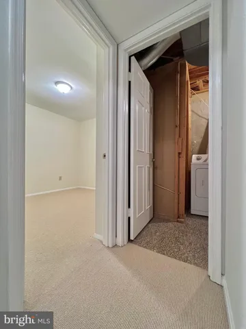 an empty room with windows and fireplace