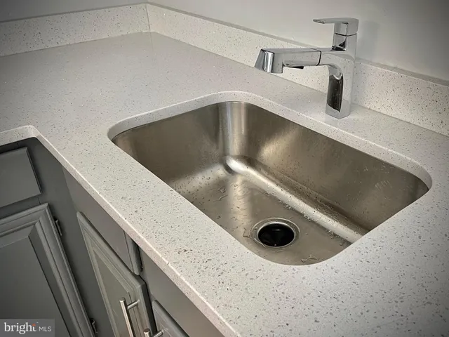 a kitchen with a sink a stove and microwave