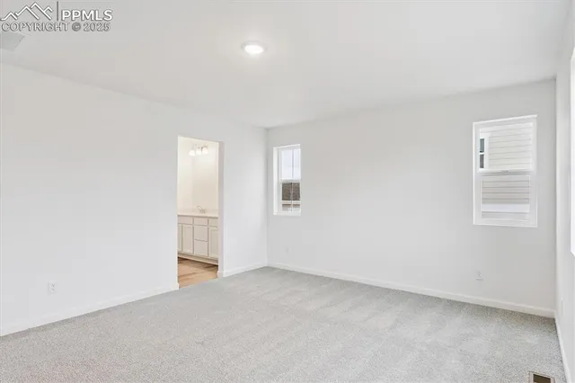 a view of an empty room and a window