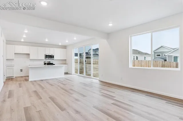 a view of kitchen with wooden floor and windows