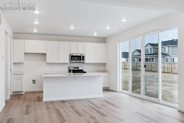 a kitchen with stainless steel appliances a sink and a refrigerator