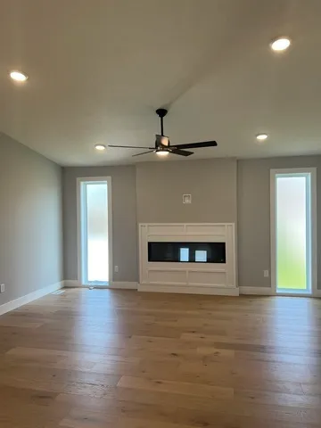 a view of a livingroom with a fireplace and window