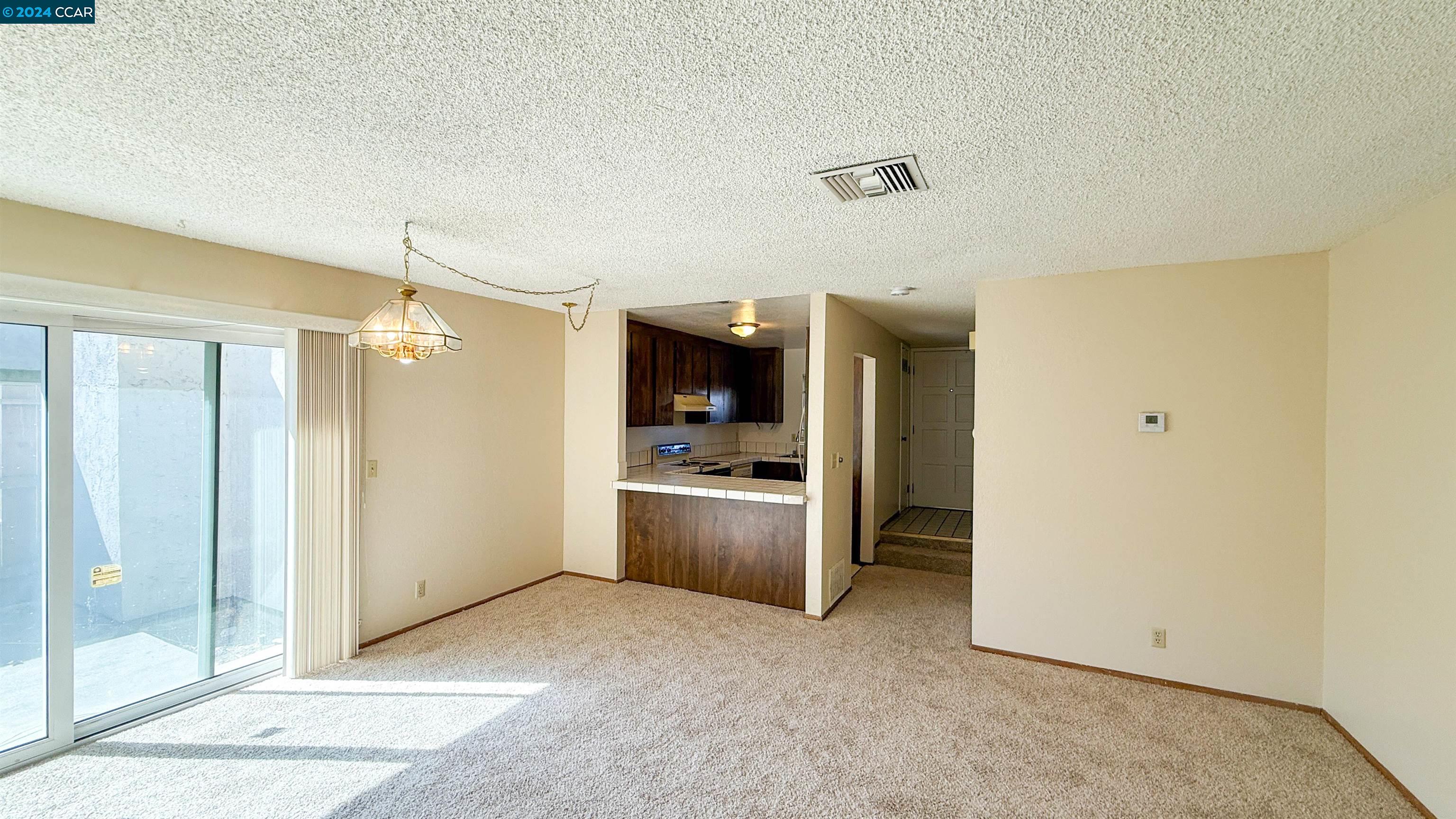 3712 Willow Pass Road, Unit 24 Concord, CA 94519 - Photo 1 of 1 a view of a kitchen with a sink and a refrigerator