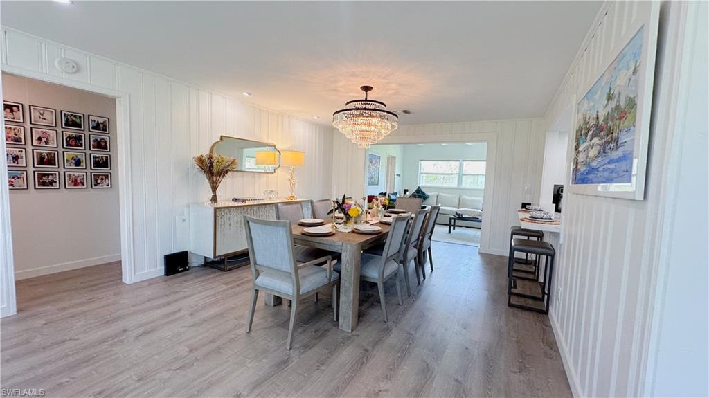 1308 Rosemary Lane Naples, FL 34103 - Photo 13 of 27 a view of a dining room with furniture and wooden floor