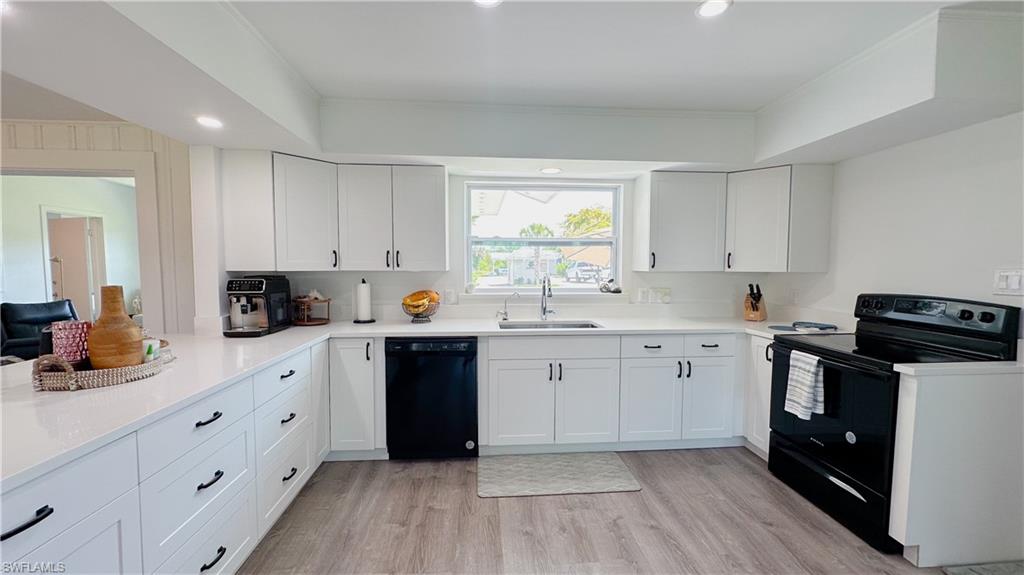 1308 Rosemary Lane Naples, FL 34103 - Photo 4 of 27 a kitchen with cabinets appliances a sink and a window