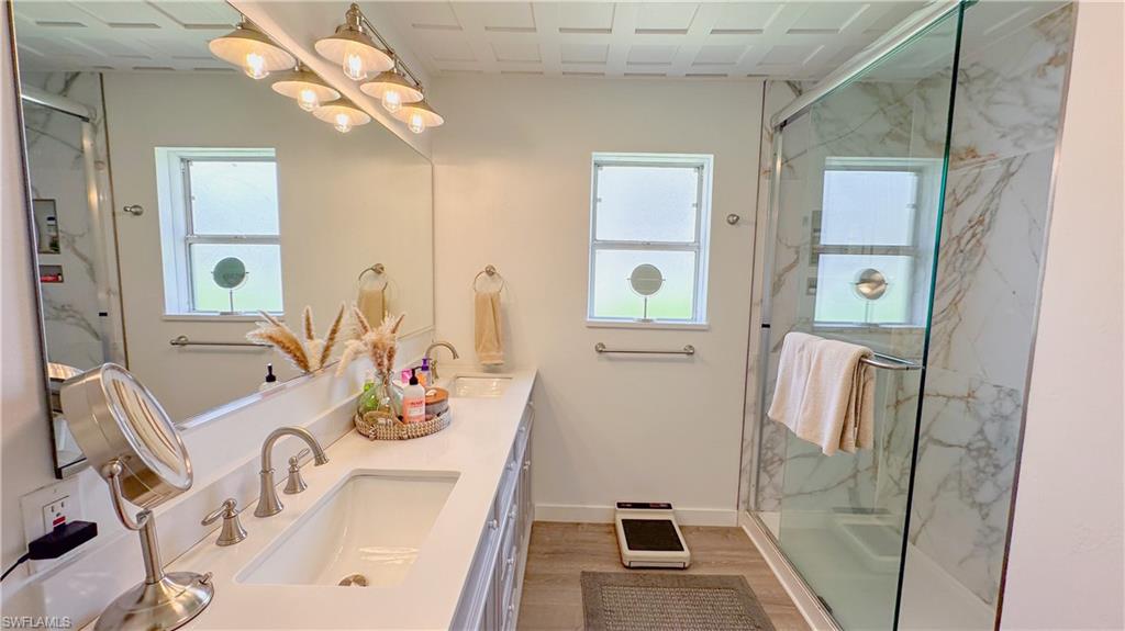1308 Rosemary Lane Naples, FL 34103 - Photo 7 of 27 a bathroom with a sink mirror and vanity