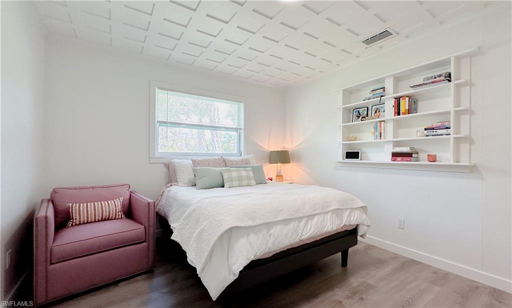 1308 Rosemary Lane Naples, FL 34103 - Photo 8 of 27 a bedroom with a bed couch and a window