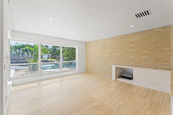 a view of a kitchen with kitchen island a sink stainless steel appliances and cabinets
