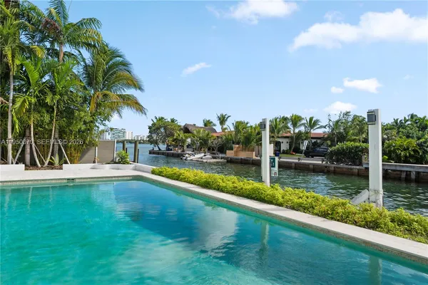 a view of a swimming pool with an outdoor seating and a garden