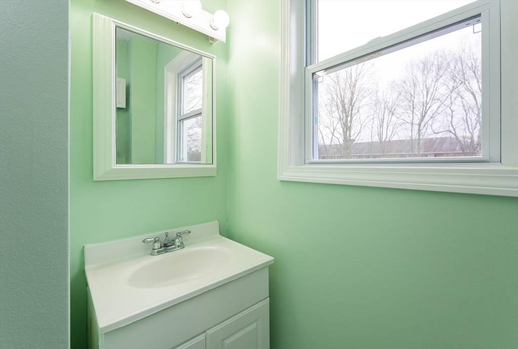 29 Mill Street, Unit B Dracut, MA 01826 - Photo 12 of 37 a bathroom with a sink and a mirror