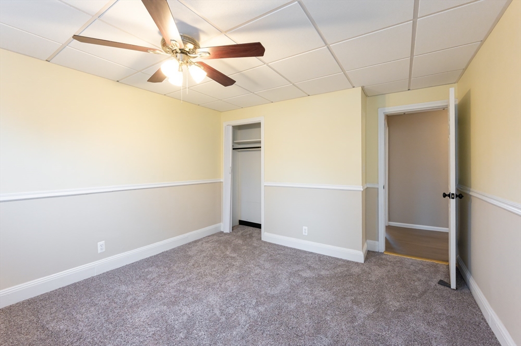 29 Mill Street, Unit B Dracut, MA 01826 - Photo 16 of 37 an empty room with closet and windows