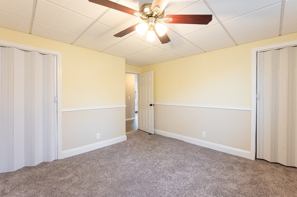 29 Mill Street, Unit B Dracut, MA 01826 - Photo 17 of 37 an empty room with chandelier fan