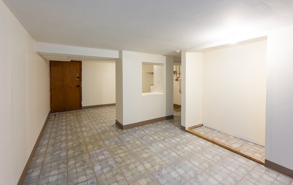 29 Mill Street, Unit B Dracut, MA 01826 - Photo 26 of 37 an empty room with windows