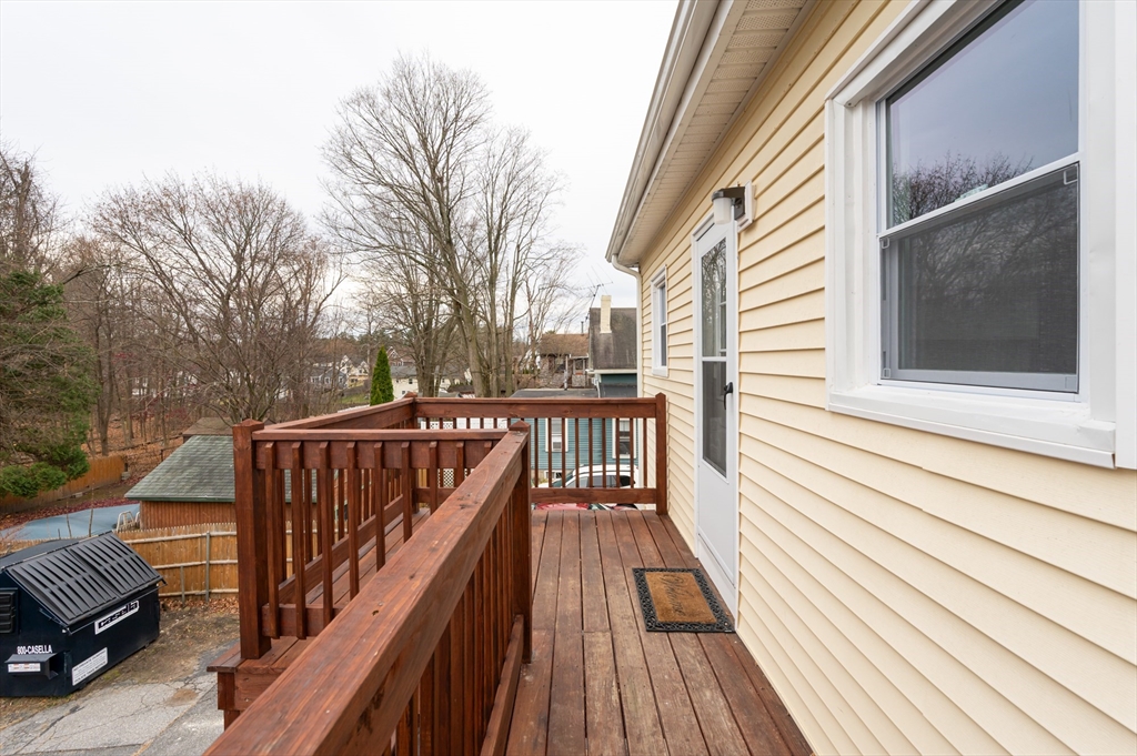 29 Mill Street, Unit B Dracut, MA 01826 - Photo 27 of 37 a view of balcony with wooden floor and seating space