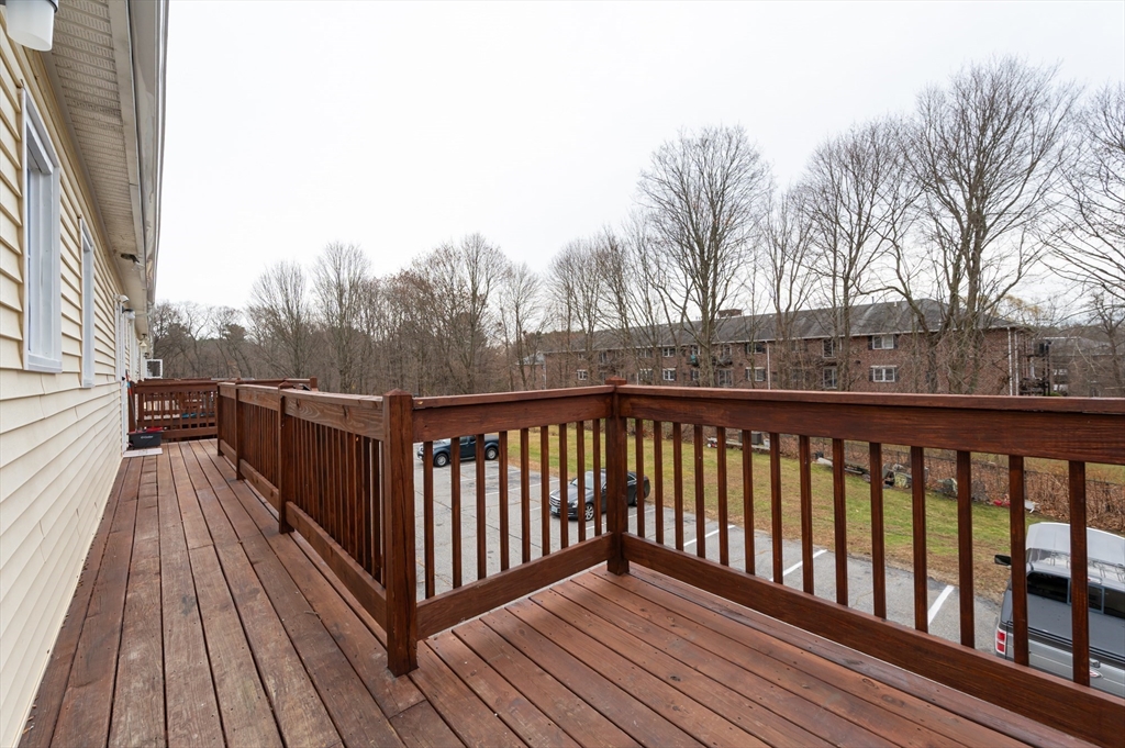 29 Mill Street, Unit B Dracut, MA 01826 - Photo 28 of 37 a view of balcony with wooden floor