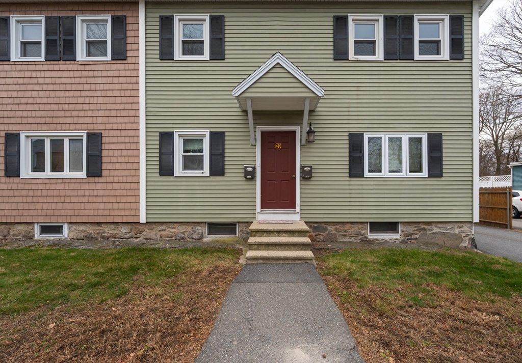 29 Mill Street, Unit B Dracut, MA 01826 - Photo 35 of 37 a front view of a house with garden