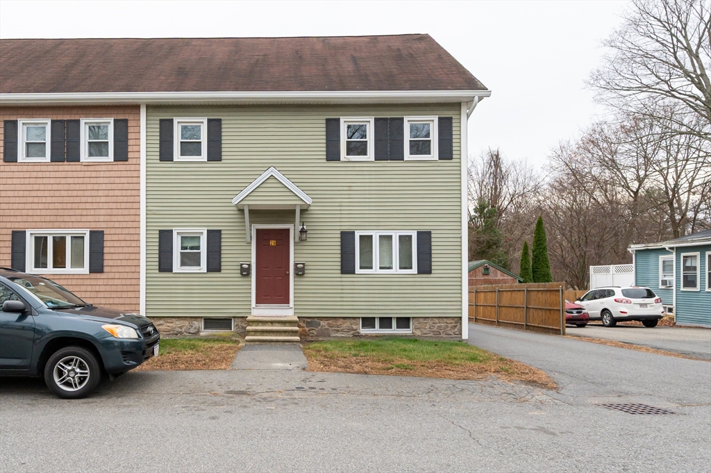 29 Mill Street, Unit B Dracut, MA 01826 - Photo 37 of 37 a front view of a house with cars parked on road