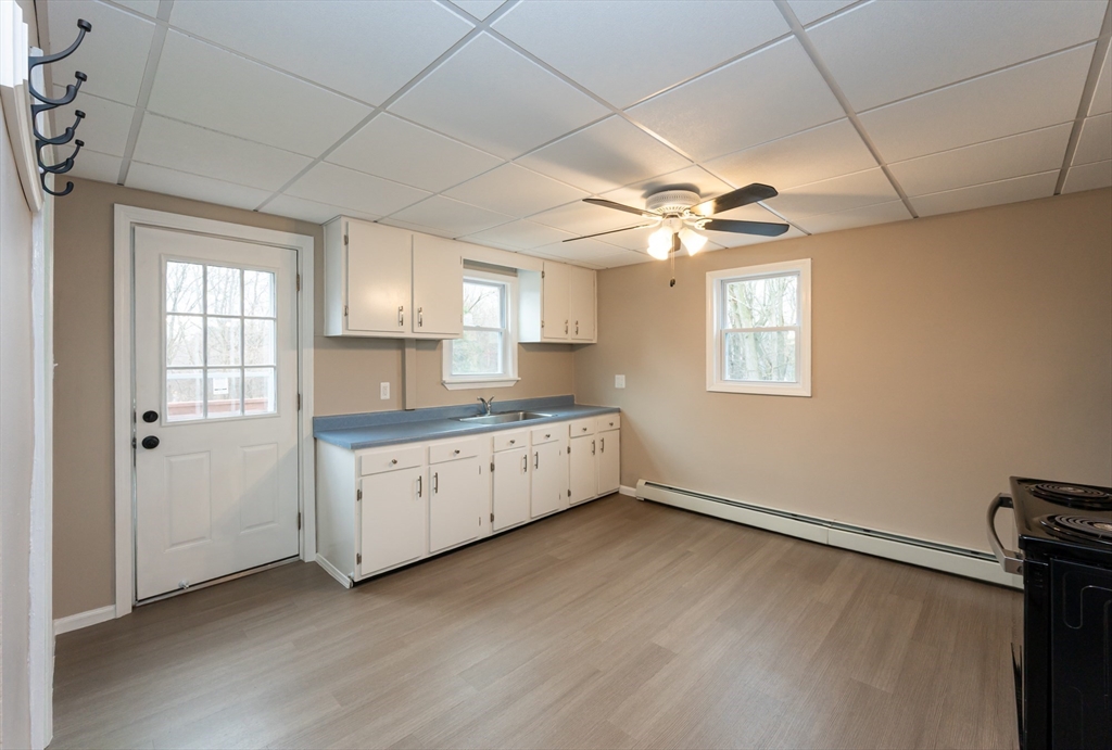 29 Mill Street, Unit B Dracut, MA 01826 - Photo 4 of 37 a view of a kitchen with a sink and a window