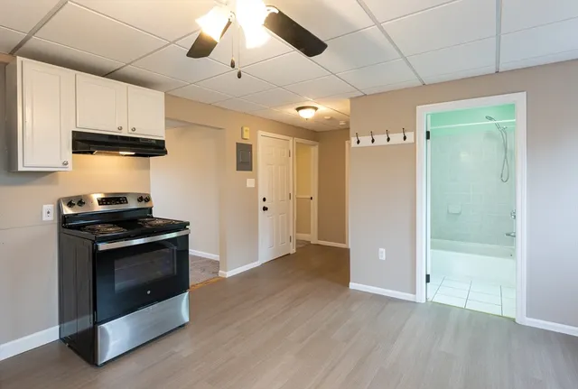 a view of a kitchen with a stove cabinets and wooden floor