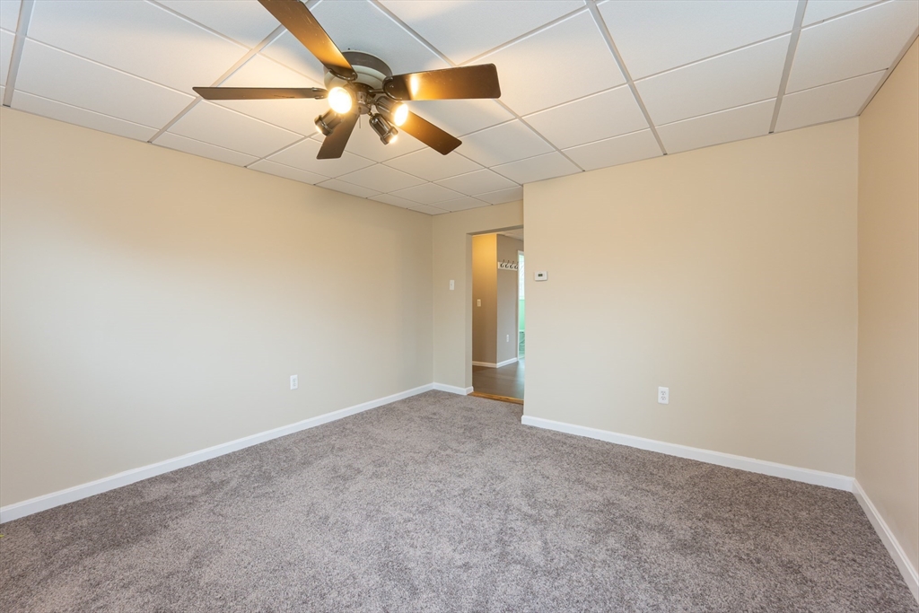 29 Mill Street, Unit B Dracut, MA 01826 - Photo 9 of 37 an empty room with projector and fan