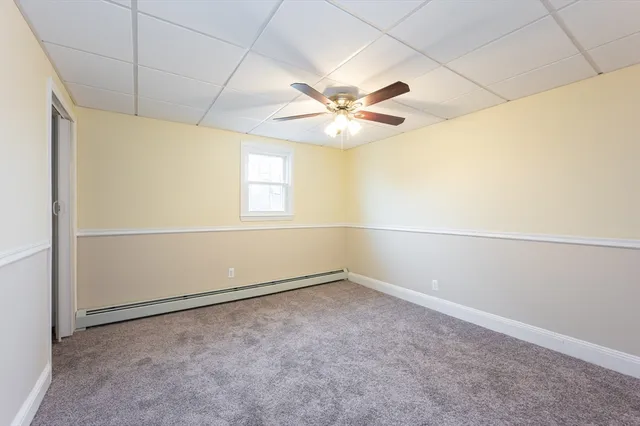 an empty room with a empty space and a ceiling fan