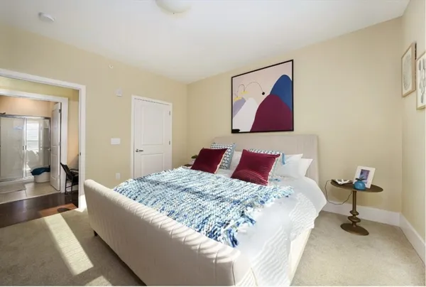 a bedroom with a bed and bathroom