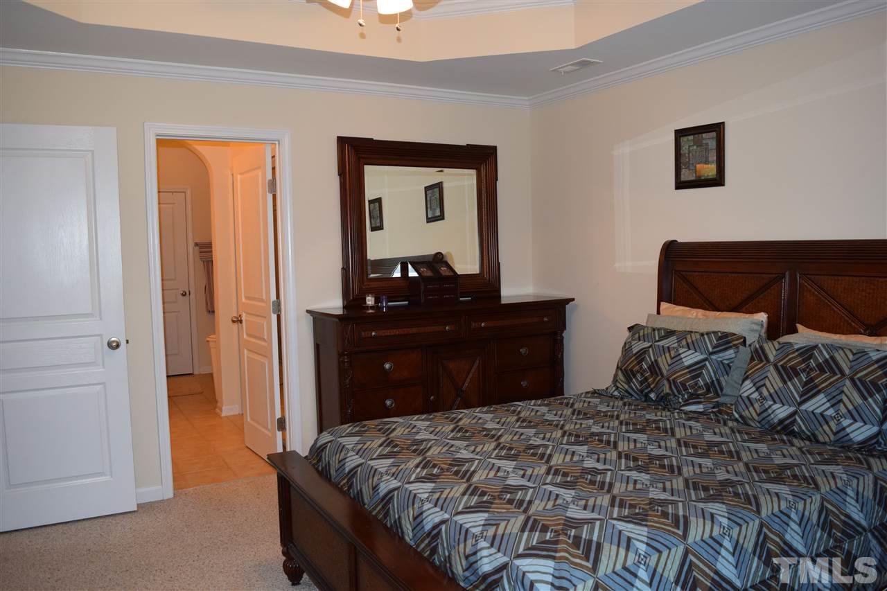 5045 Celtic Court Raleigh, NC 27612 - Photo 11 of 25 a bedroom with a bed and a dresser