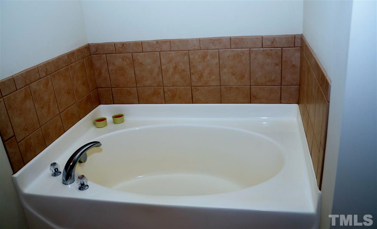 5045 Celtic Court Raleigh, NC 27612 - Photo 12 of 25 a bathroom with a bathtub