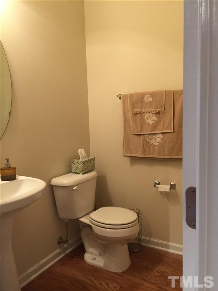 5045 Celtic Court Raleigh, NC 27612 - Photo 13 of 25 a white toilet sitting next to a bathroom sink