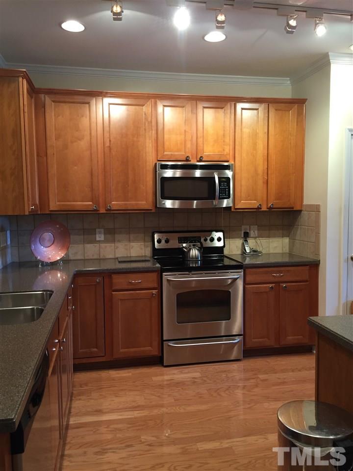 5045 Celtic Court Raleigh, NC 27612 - Photo 3 of 25 a kitchen with stainless steel appliances granite countertop a stove a sink and a microwave