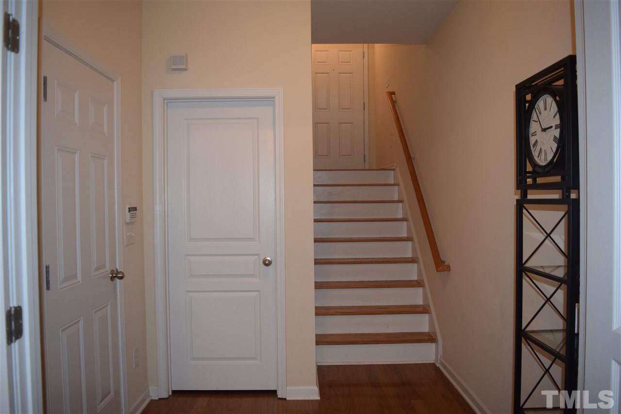 5045 Celtic Court Raleigh, NC 27612 - Photo 22 of 25 a view of entryway with stairs and wooden floor
