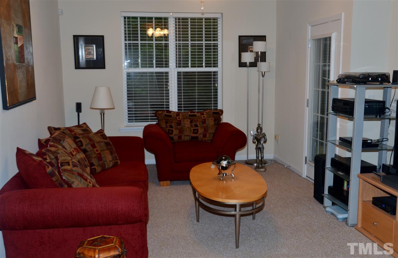 5045 Celtic Court Raleigh, NC 27612 - Photo 6 of 25 a living room with furniture a flat screen tv and a window