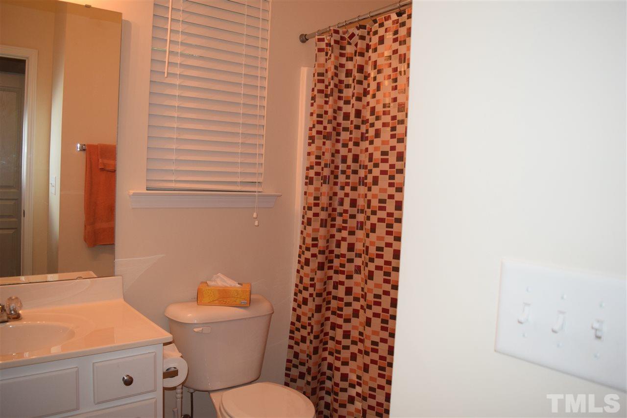 5045 Celtic Court Raleigh, NC 27612 - Photo 9 of 25 a bathroom with a toilet a sink and a shower