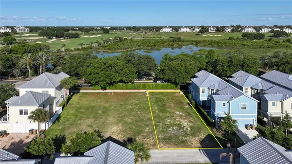 an aerial view of residential houses with outdoor space and street view