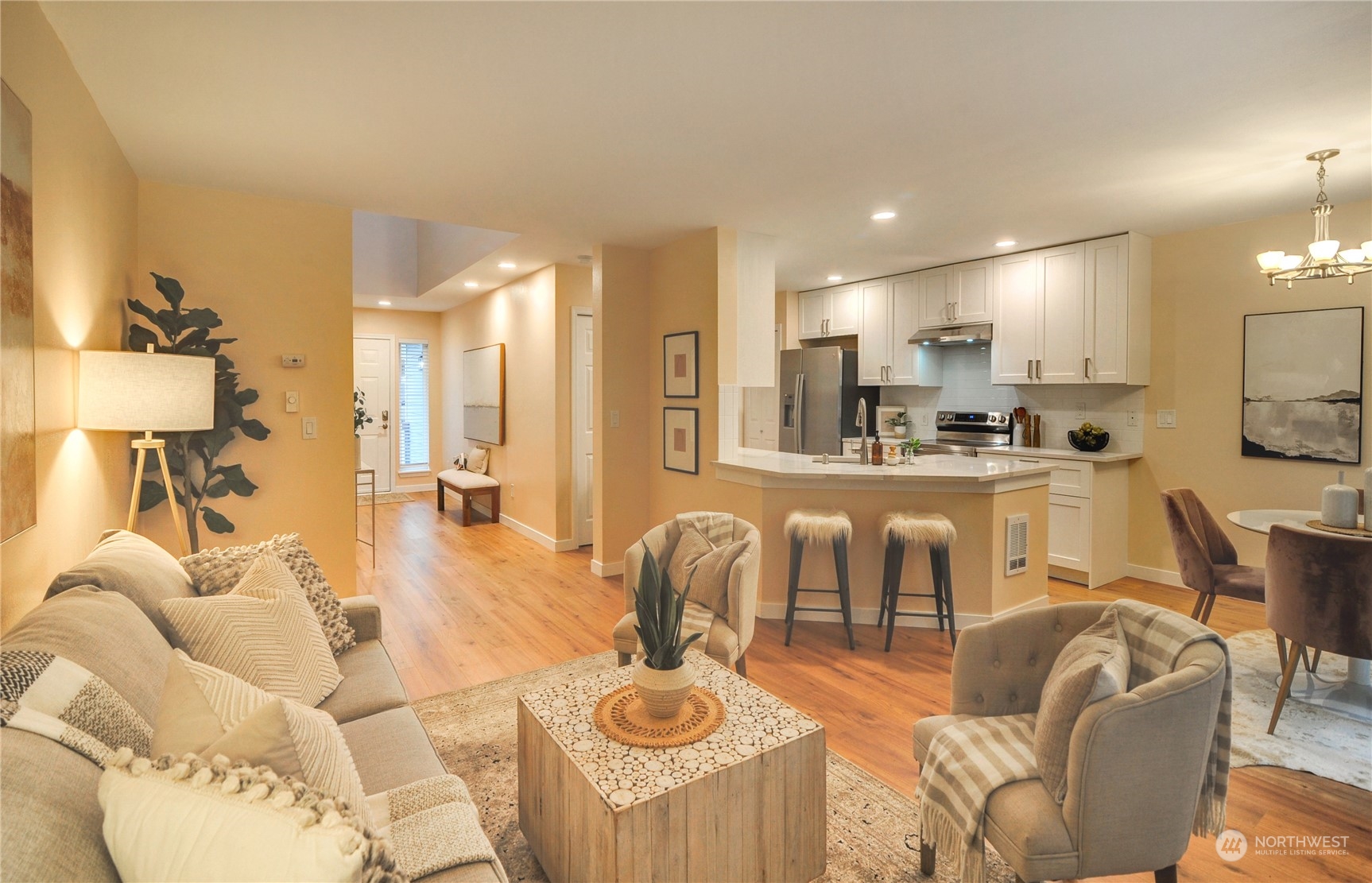 23111 15th Avenue Southeast, Unit E3 Bothell, WA 98021 - Photo 13 of 30 a living room with furniture kitchen view and a wooden floor