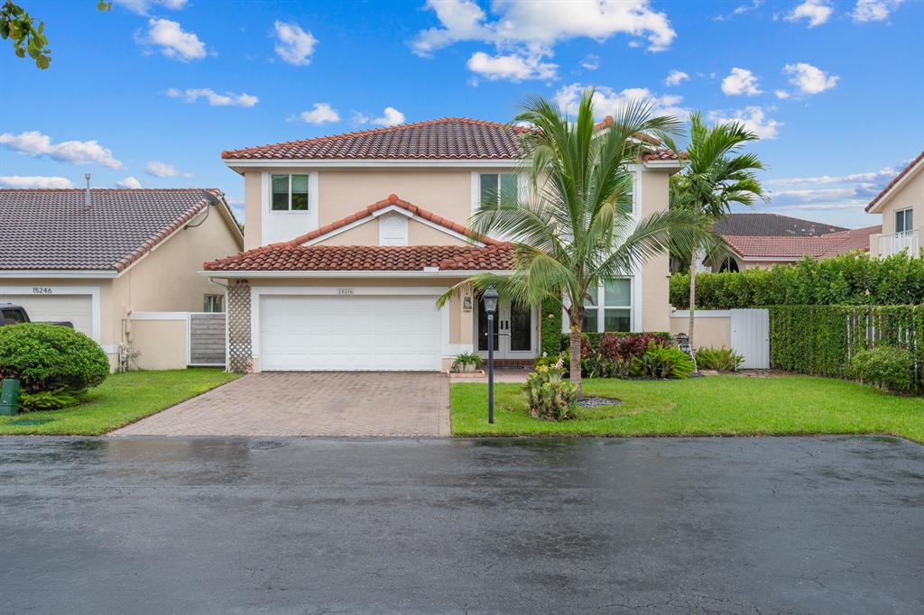 a front view of a house with a yard and garage