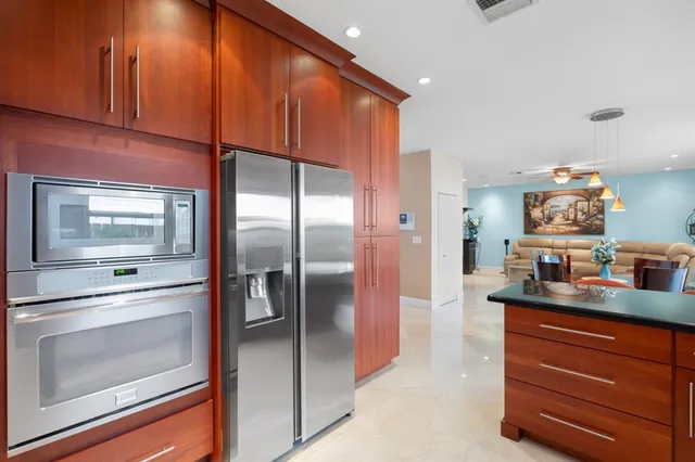 a kitchen with stainless steel appliances a refrigerator and a stove